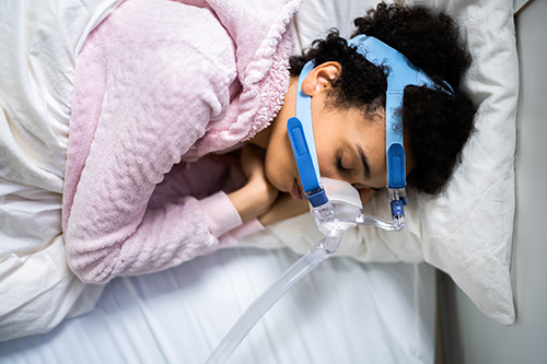sleep apnea equipment on sleeping woman