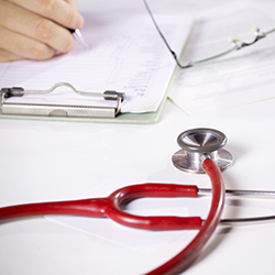 Red stethoscope on a desk