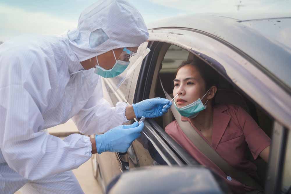 COVID-19 testing at drive through lab with swabs