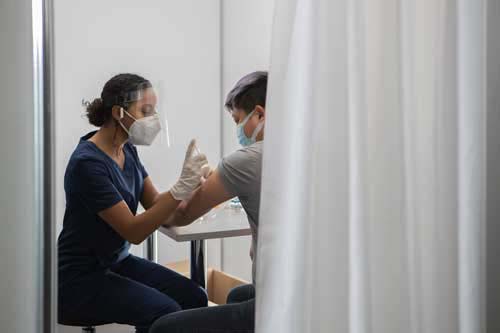 A nurse vaccinates a patient