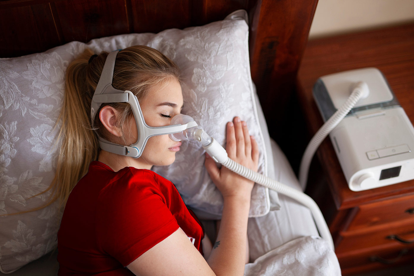 Woman asleep while wearing a breathing mask