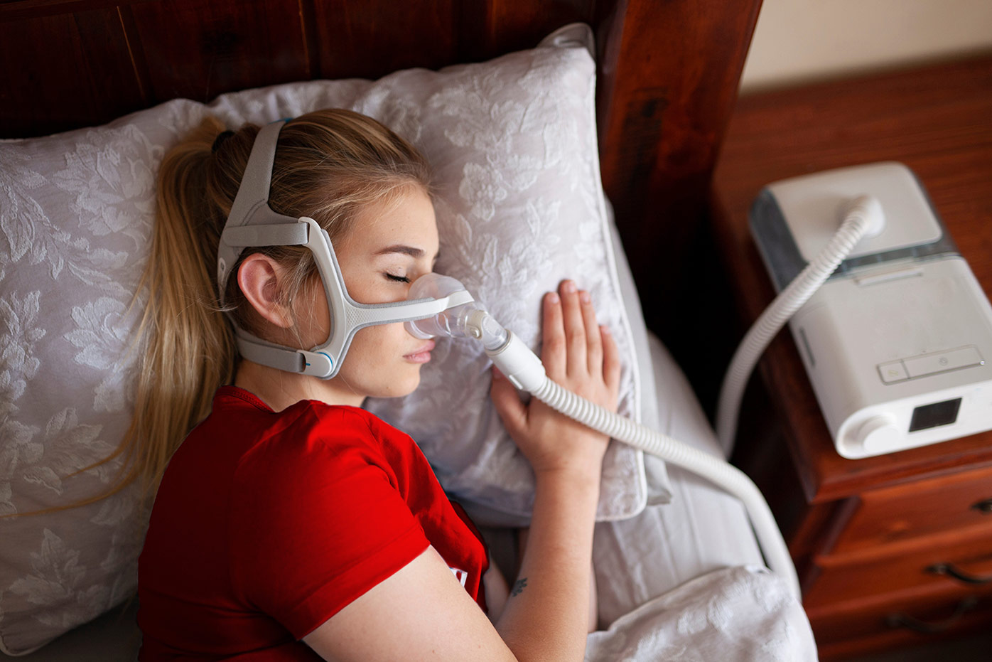 Woman sleeping with sleep apnea mask