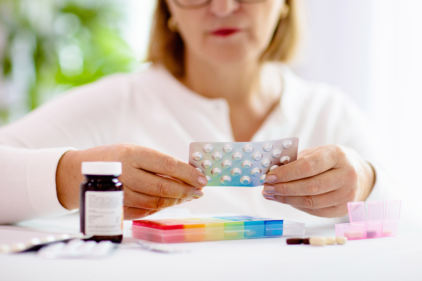 Woman looking at multiple pills