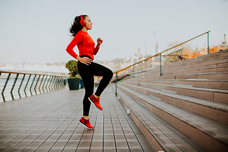 Woman running while wearing headphones