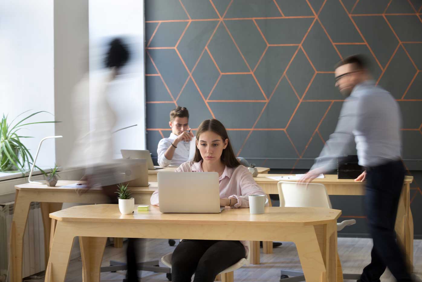 A woman at work in a busy office