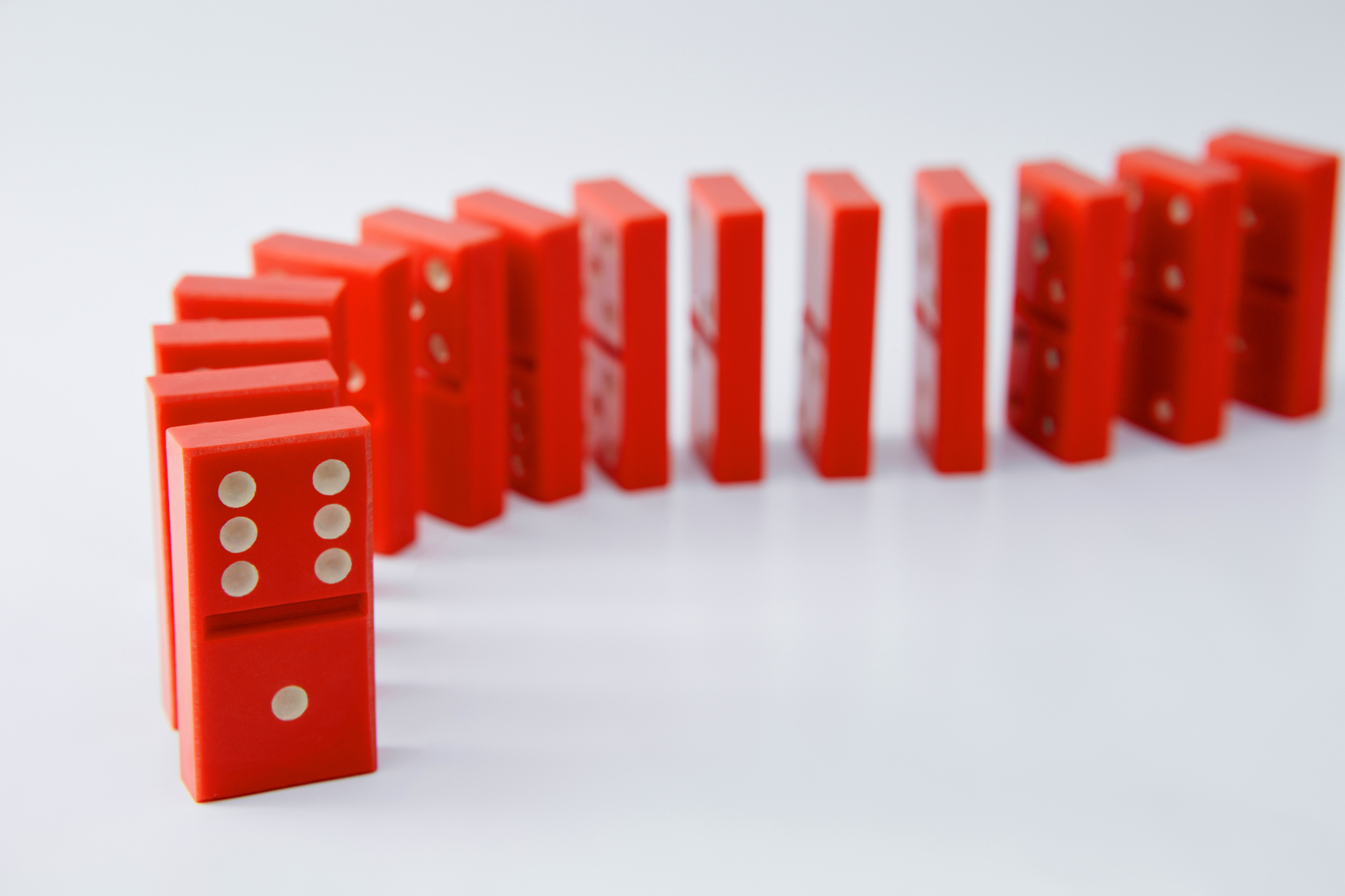Red dominoes set up ready to fall.