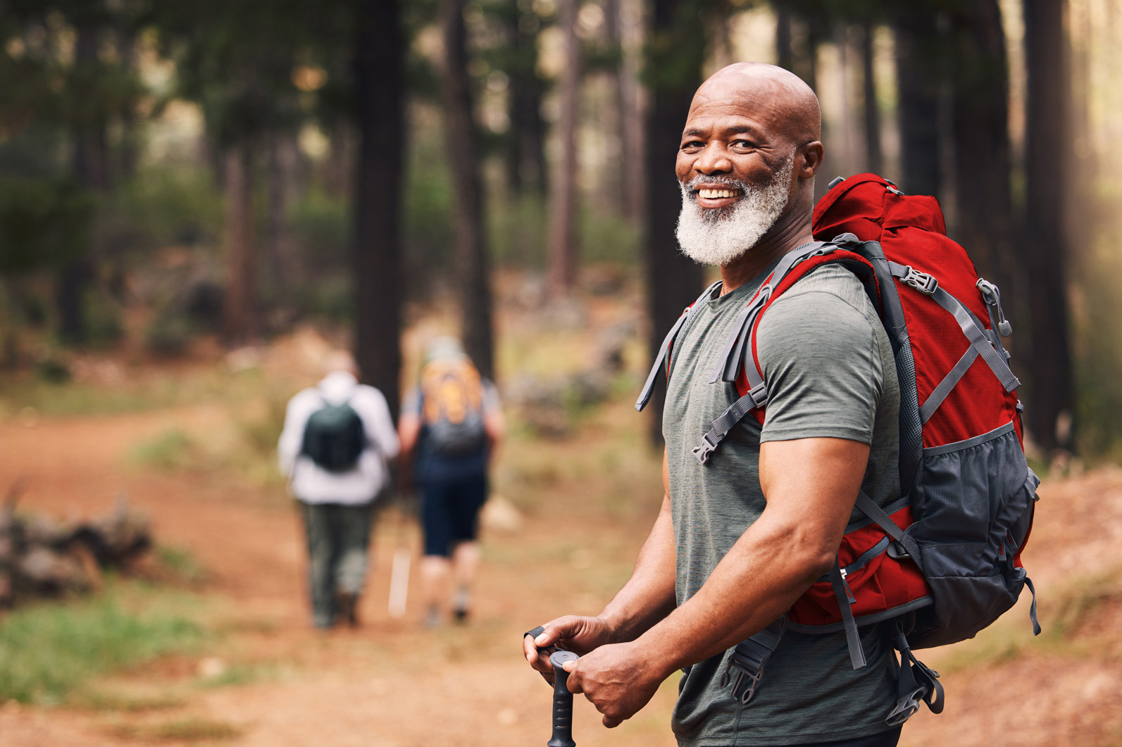 Man pausing during a hike in the woods