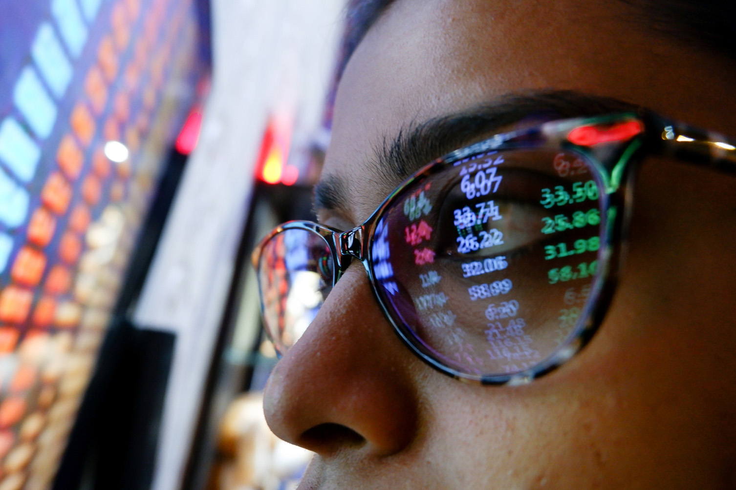 Stock prices reflected in glasses