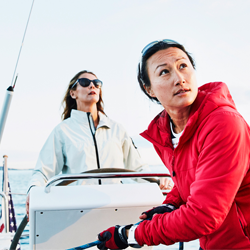 A pair of sailors on a boat looking into the distance