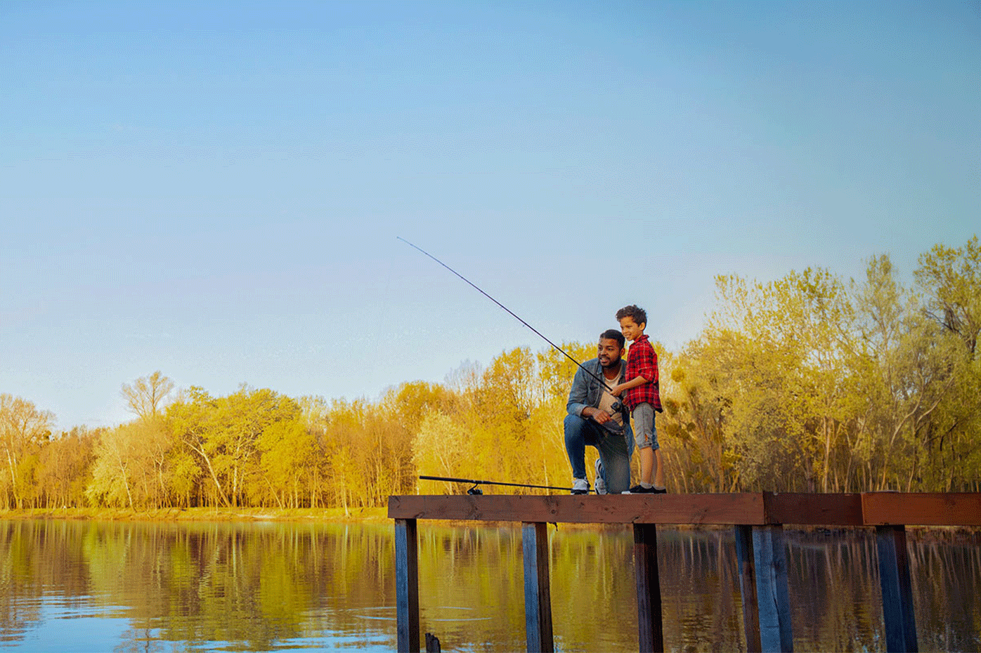 A father and son fishing on a fishing dock