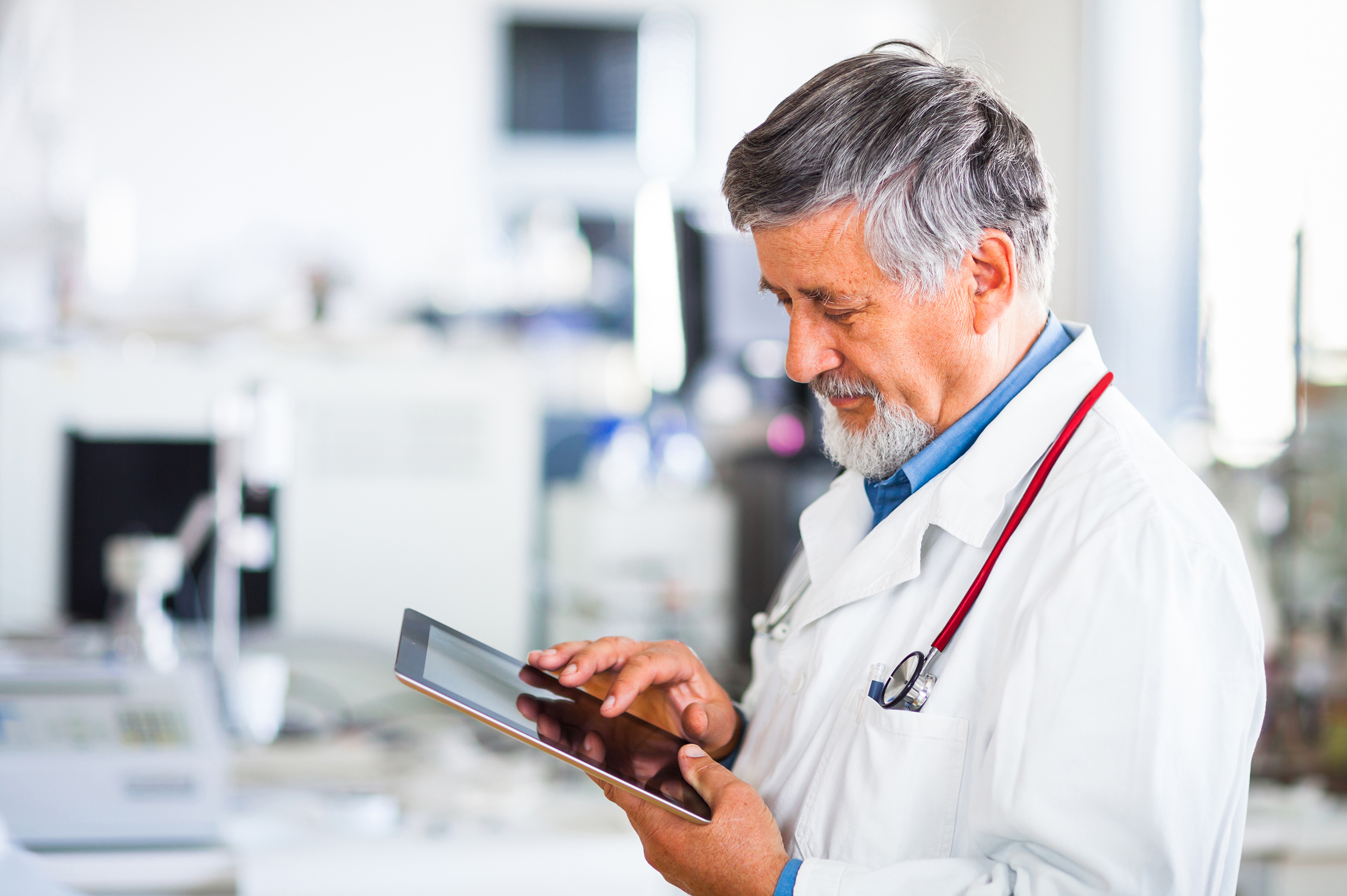 Doctor looking at a report on a tablet