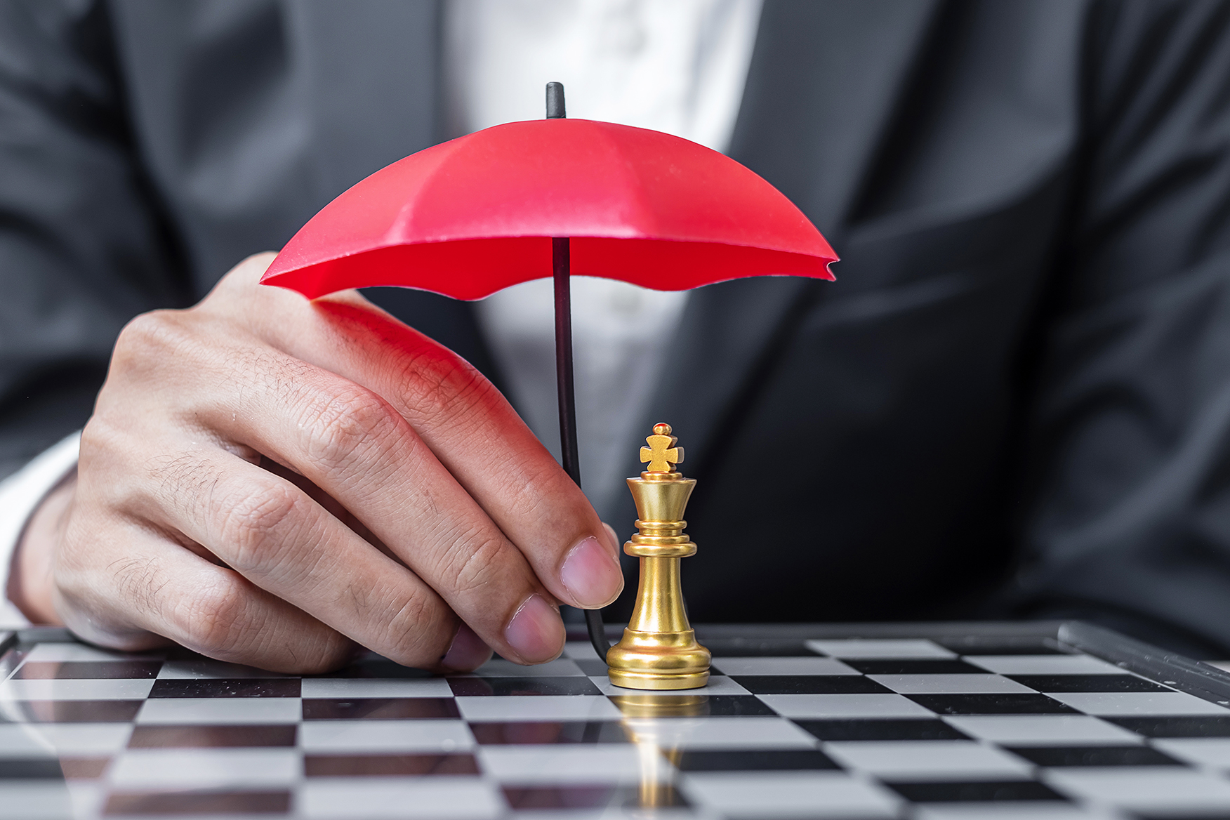 Umbrella over a chess king piece
