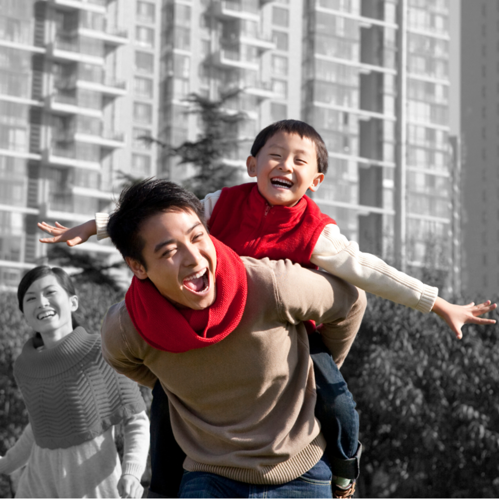 Family with father giving son a ride on his back