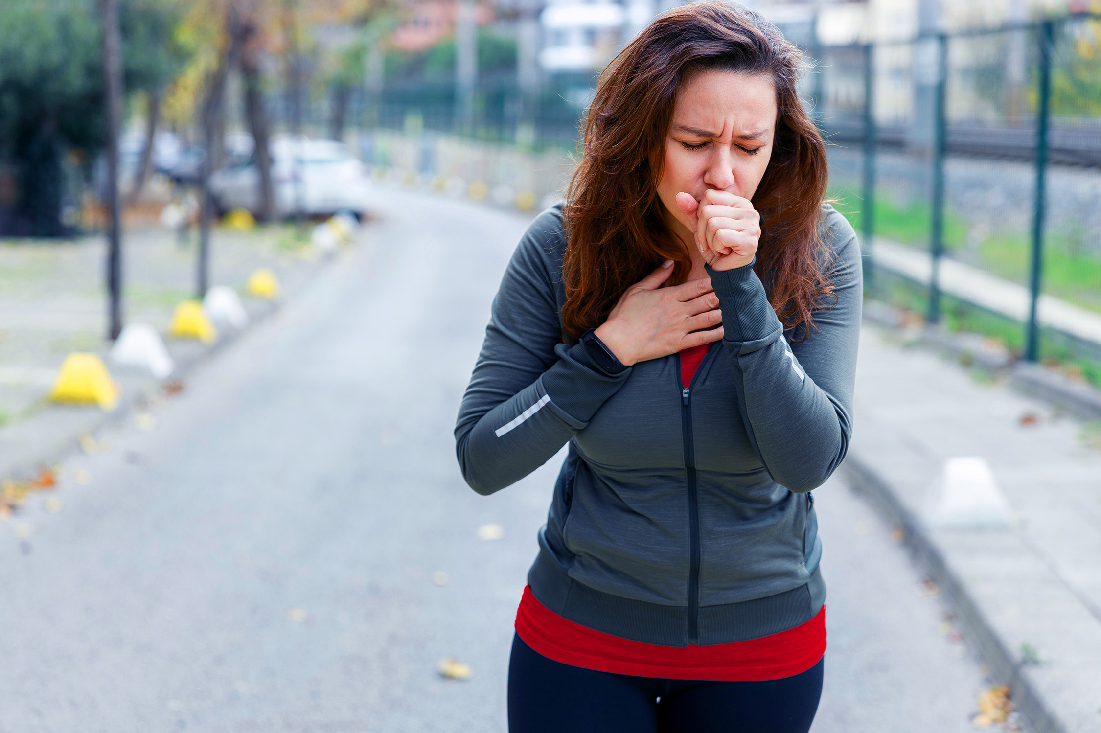 Woman outside coughing