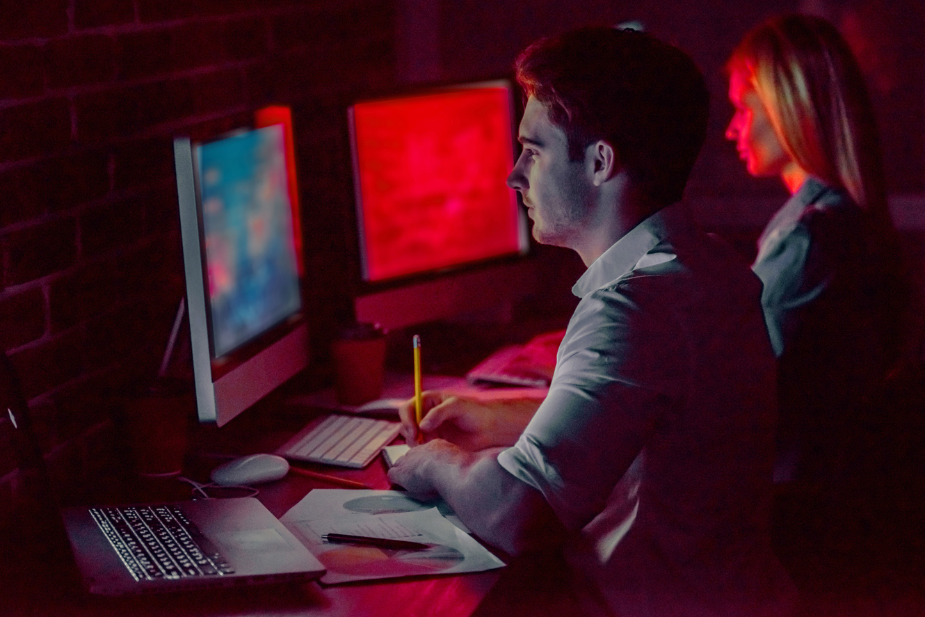 Duo working at night on fraud detection