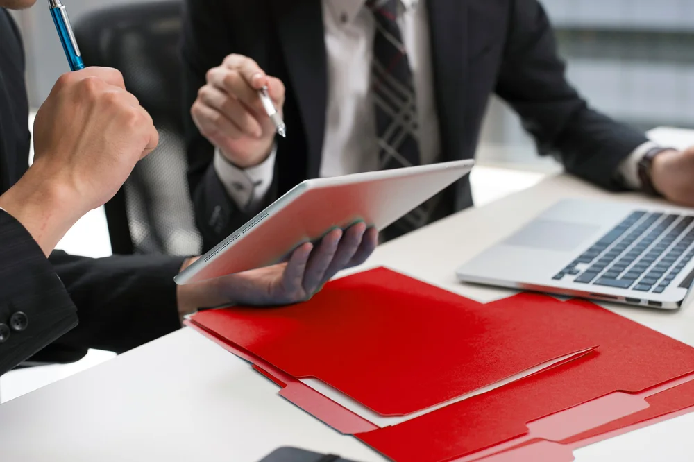 Two Businesspeople Analyzing a Tablet Screen
