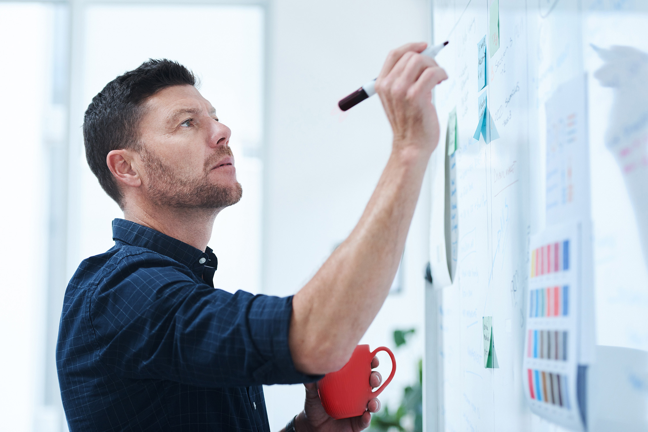A man carefully explores patterns on a whiteboard