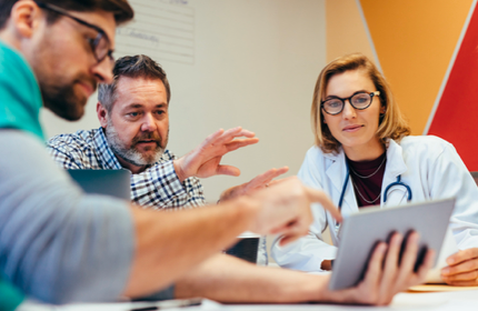 Doctors and Nurses Analyzing Data on Tablet