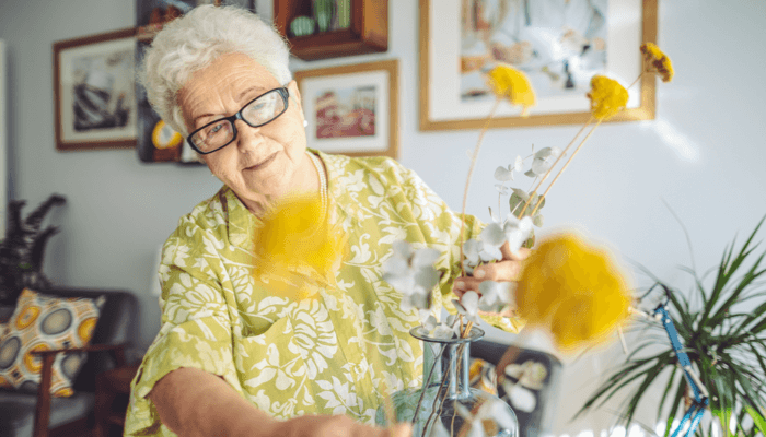 Elderly Woman Arranging Flowers
