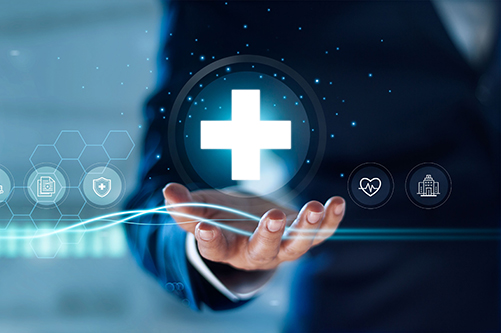 A view of a hand holding a white cross symbolizing medicine