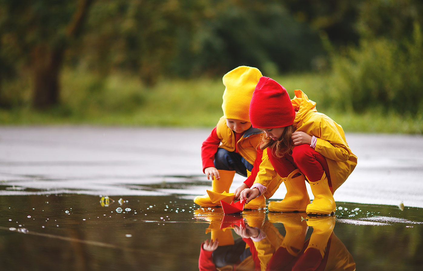 A pair of young girls gaze into a reflective pool