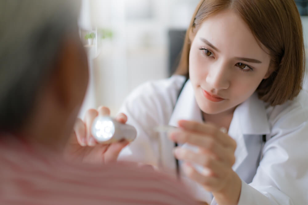 Female internist physican performs examination