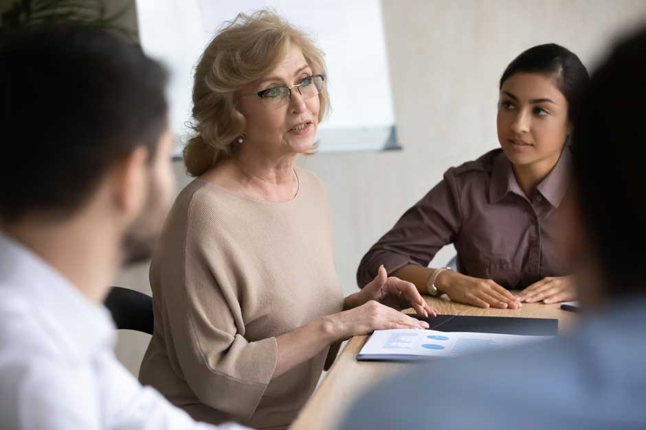 Claims analysts convene to discuss a difficult case