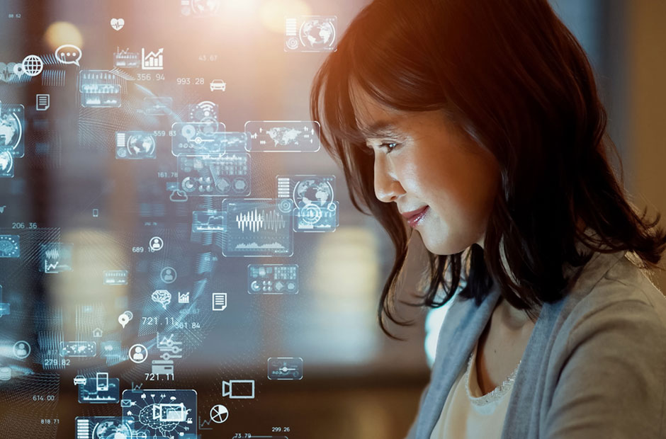A woman focuses intently on computer with data illustration
