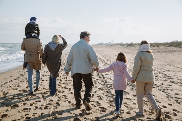 Reinsurance Protects People A family walks along the beach