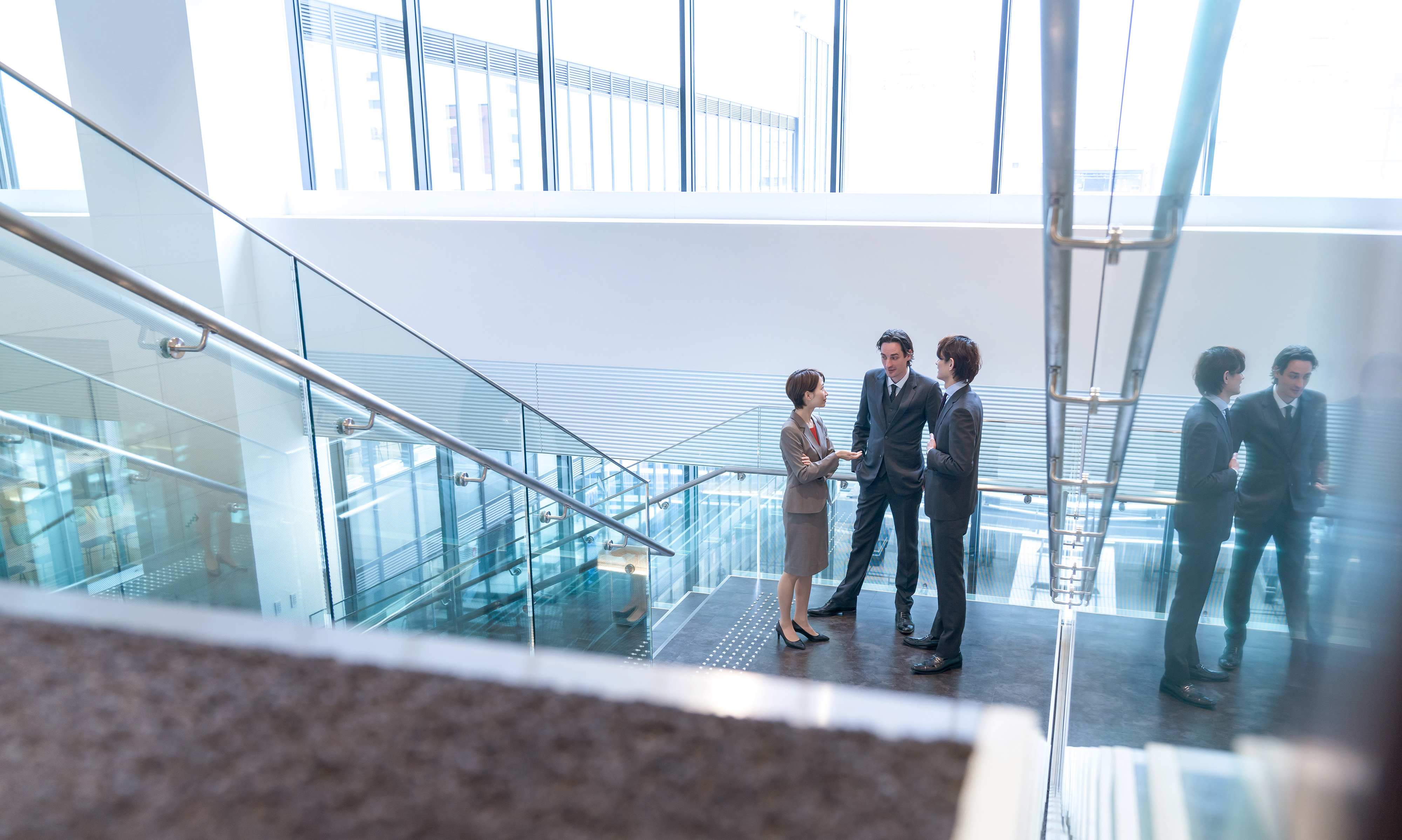 Three Businesspeople in Conversation at an Office