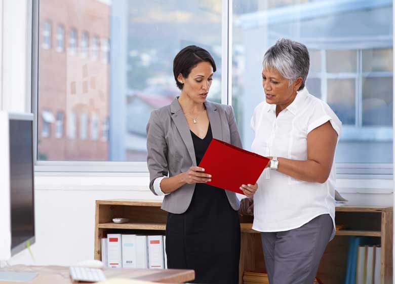 A pair of claims analysts review a case