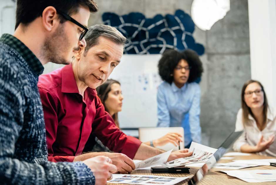 A group of executives studies the results of focus group research