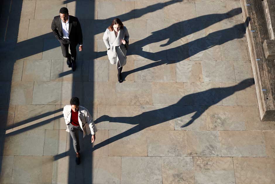 An overhead shot of commuters on a busy city street