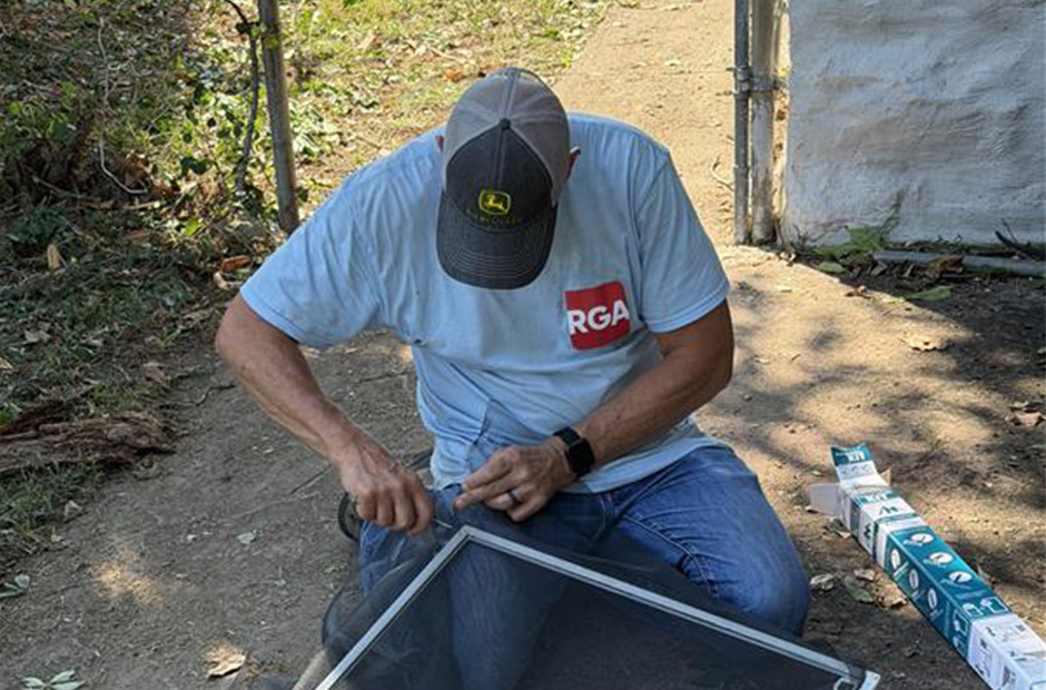 RGA employee building a screen door