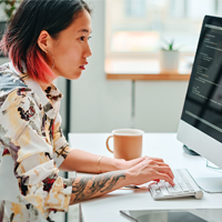 A young female actuary works at a computer.