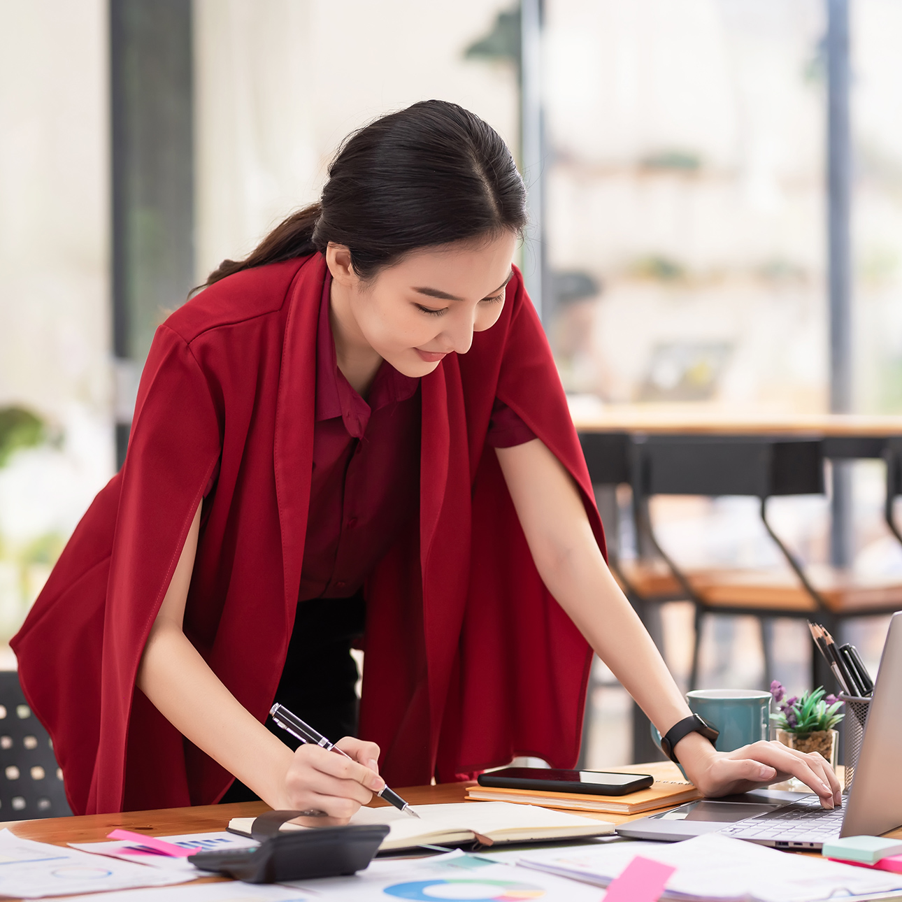 Women taking notes while looking at a computer.