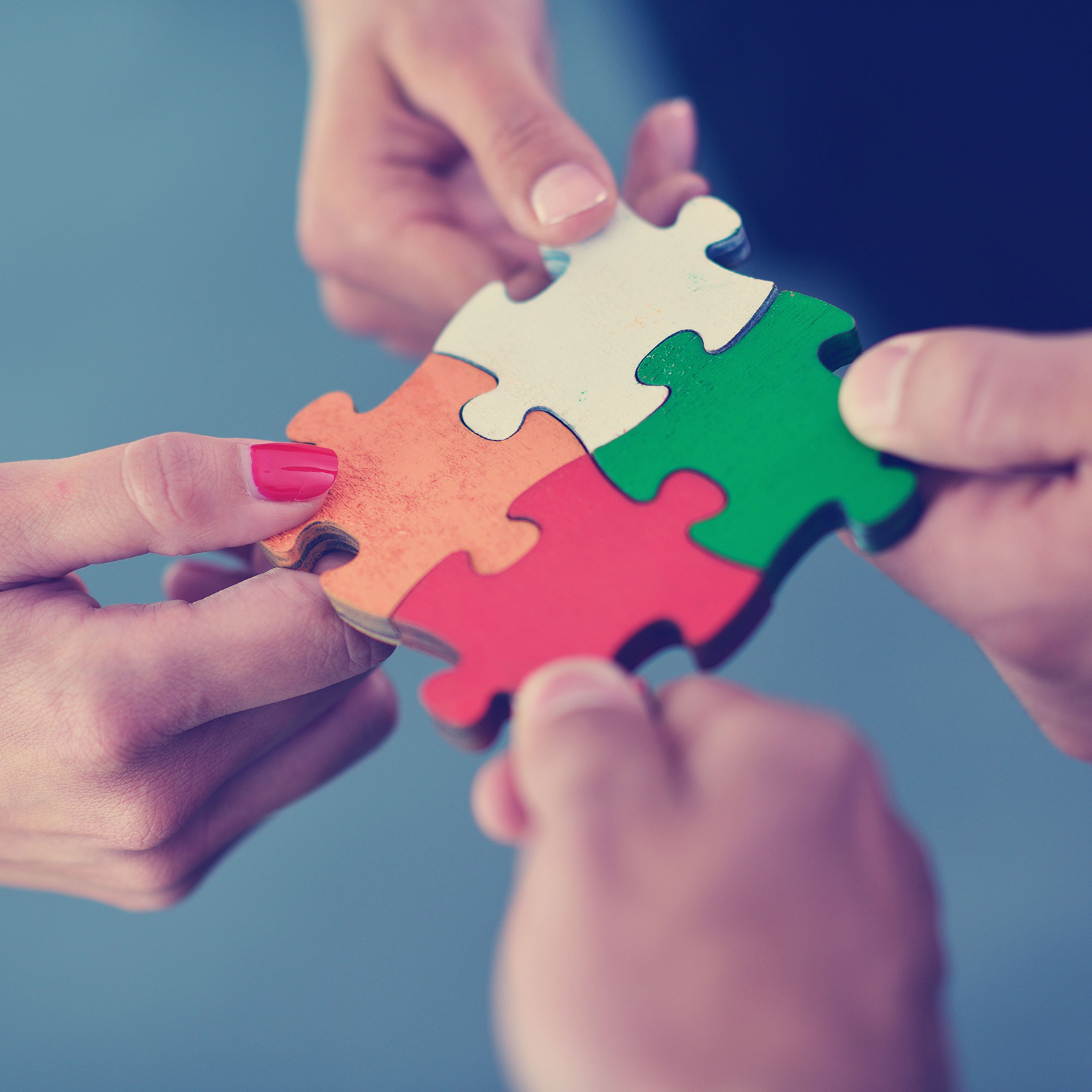 People putting puzzle pieces together