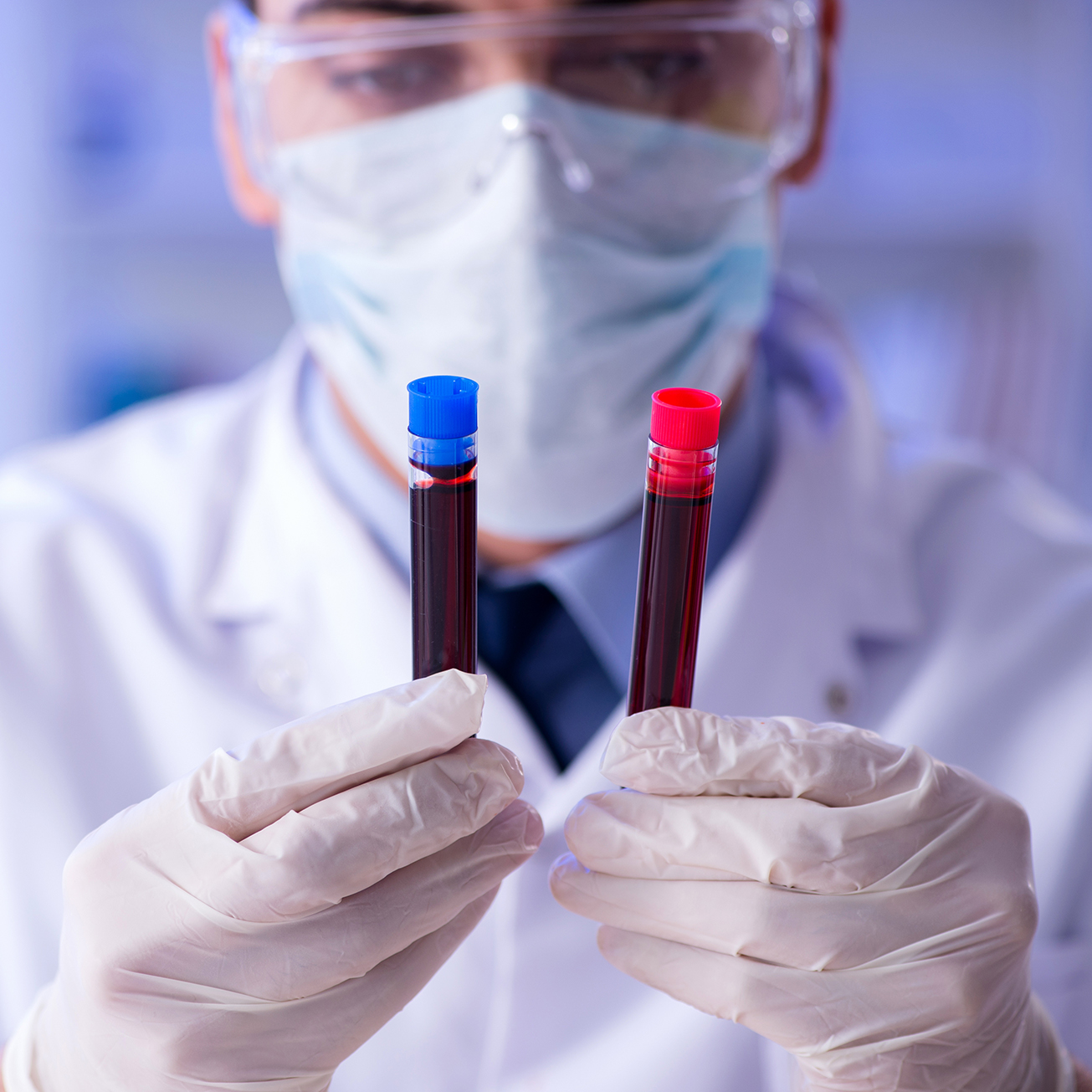 Doctor holding two vials of blood