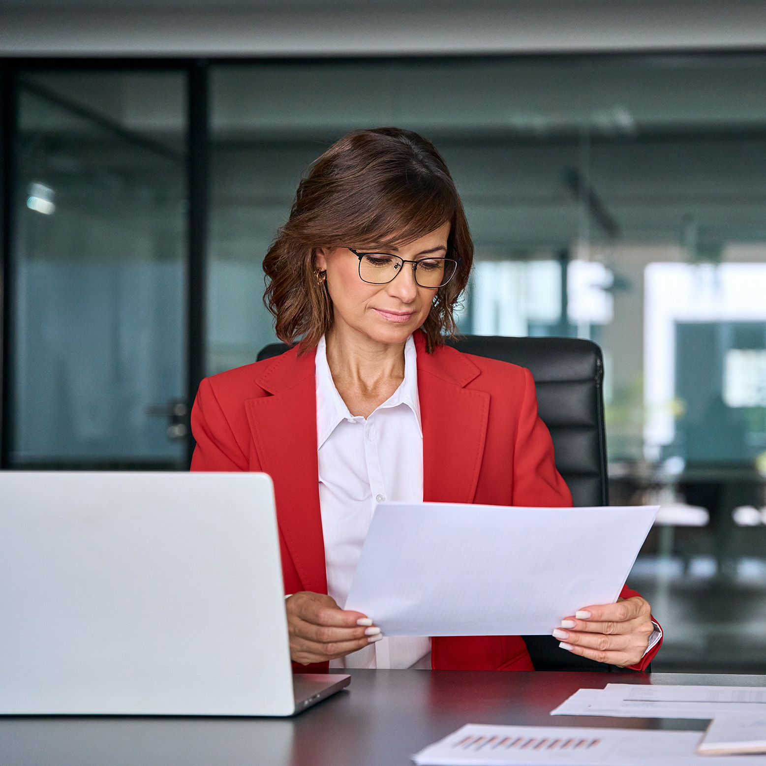 A woman reviewing a white paper