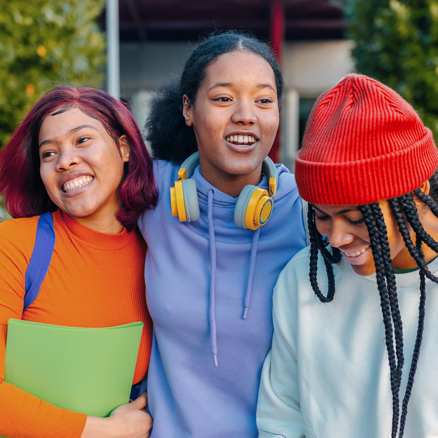 Three teen girls smiling