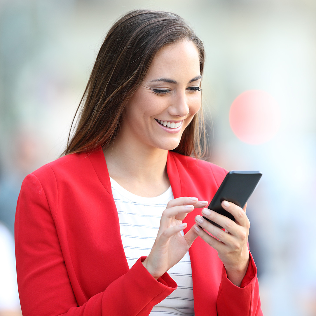 Woman in red jacket on the phone