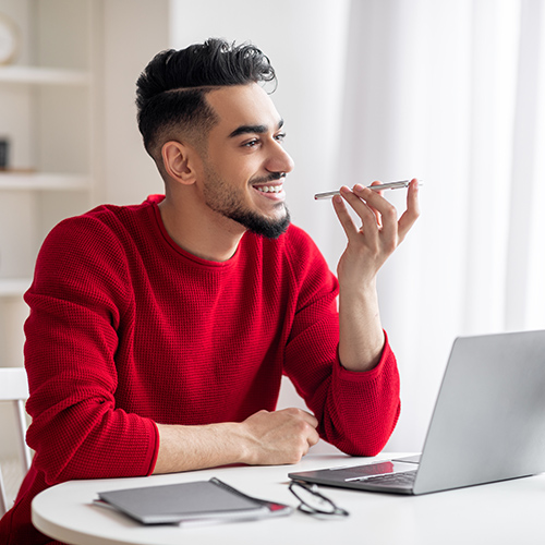 Man in a red sweater talking on the phone.