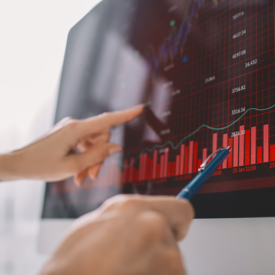 Two people looking at a financial chart