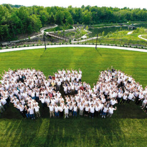 Group photo of employees forming a human RGA to mark anniversary