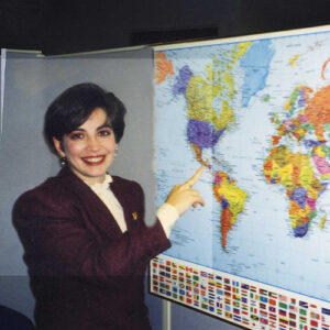 An employee gesturing to RGA's global expansion on a map