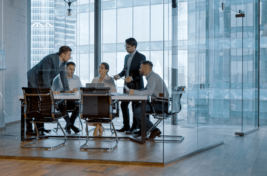 A group of dealmakers meet in an elegant office tower